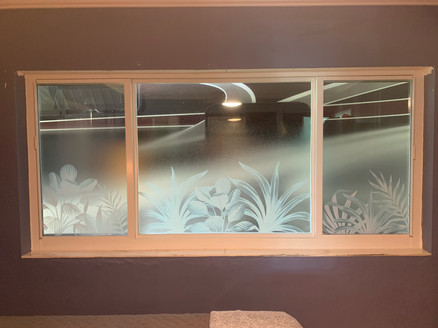 Custom decorative design with tropical plants in white frost. Background is a gradient in in clear frost that leaves 25% of the glass clear ( on top).