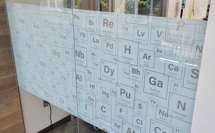 decorative glass wall design with periodic table of elements. Design for School in MN. White frost with 80% white point and clear frost lettering and liens. High opacity.