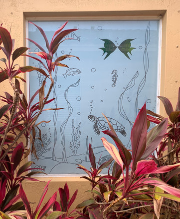 custom decorative underwater world design for a large bathroom window. the objective was to stop the view of the neighbor's bathroom and viceversa.