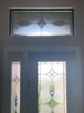 Decorative custom design on transom to accompany the existing decorative glass design for the door. Clear frost and texture.