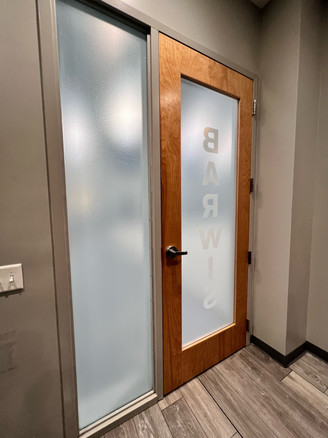 Custom decorative white frost. White point at 20% for the background on both glass panes. Interior Commercial door with logo with white point higher than the background to create contrast.