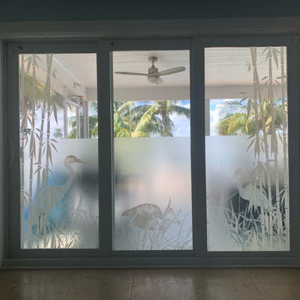 Sliding Glass doors with decorative window film. Partially clear to let you see outside
