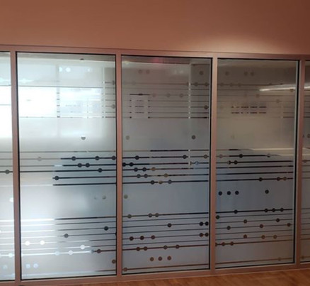 White frost custom decorative design for Children Hospital. Music score in clear areas, white frost background. Music progresses from pane to pane and it is never the same.
