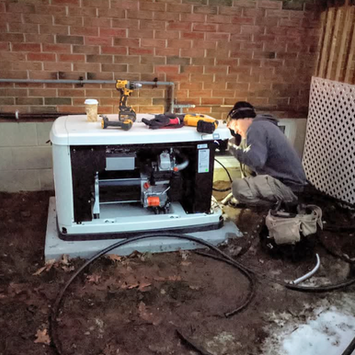 Technician installing home standby generator