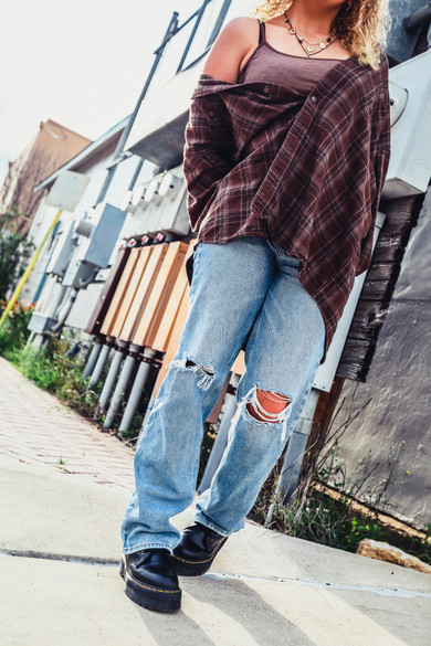 Cool Trendy Modern outfit of Doc Martens, pac sun jeans, oversized flannel 