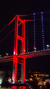 Illuminated in red color big Bosphorus Bridge - view during Bosphorus Night Cruise with Blue Brothers