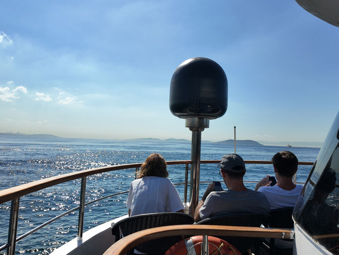 Travelers relaxing on boat heading to Princes Islands from Istanbul sea tour
