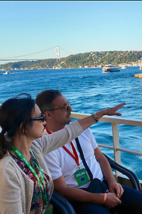 Tourists observing landmarks on the Bosphorus cruise in Istanbul