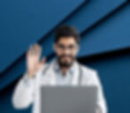 Bearded doctor waving and smiling, laptop on desk, blue background, VCam.