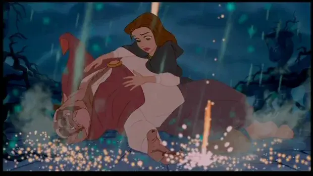 Belle is surprised as the Beast's transformation begins to occur at the end of Beauty and the Beast