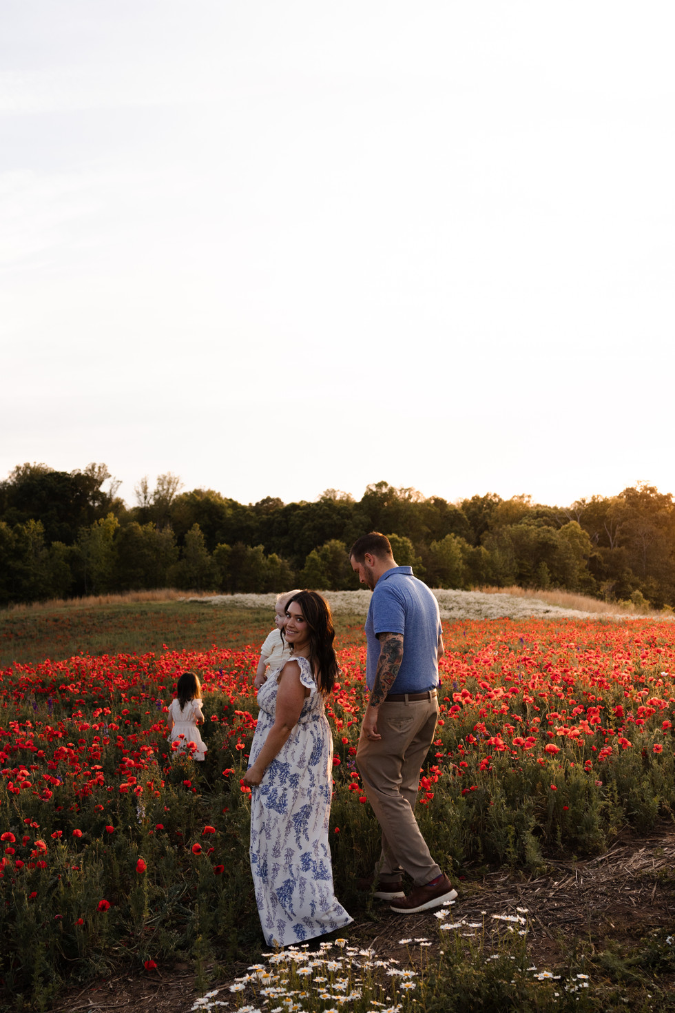 family of four in a flower field