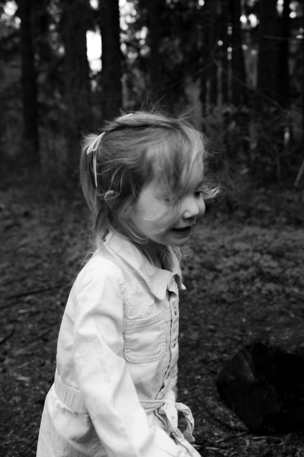 a little girl playing in the forest