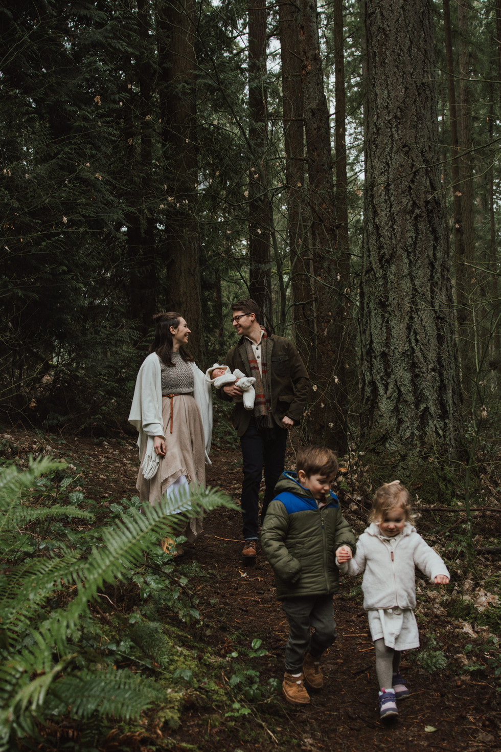 a family of 5 walking in the forest