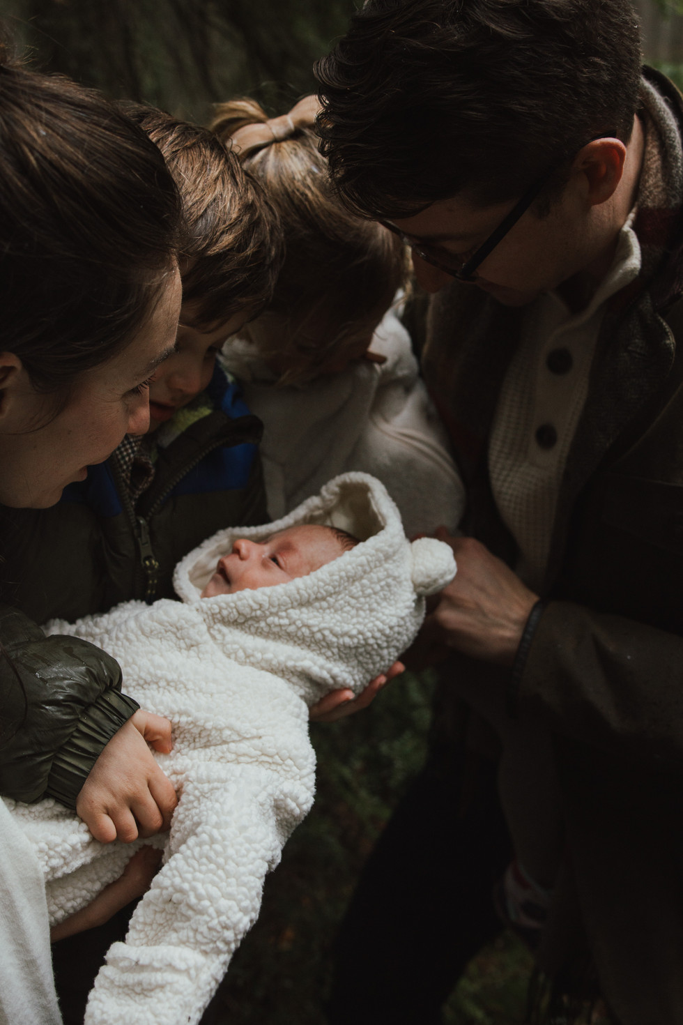 a family of 5 playing in the forest