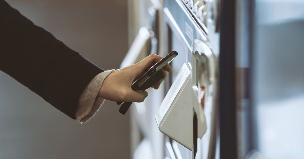 Worker uses a GrabGoVend vending machine in a Summit, NJ break room.