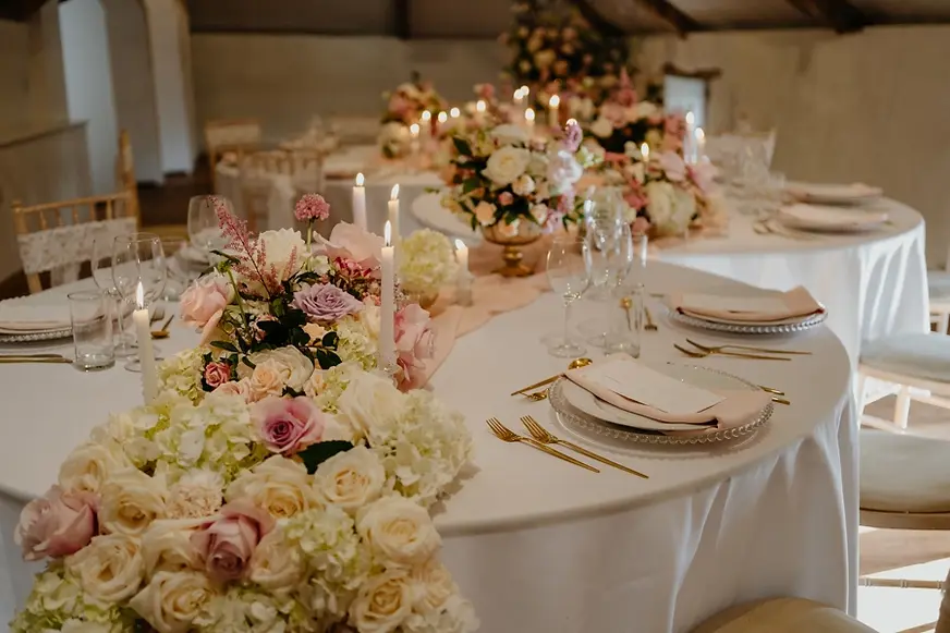 Elegant wedding reception styling with layered florals, candlelight and refined table deta