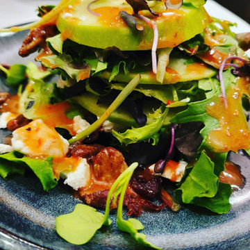 Apple Goat Cheese and Cranberry Salad, with mixed Greens Topped with Candied Pecan Finished with Raspberry Vinaigrette