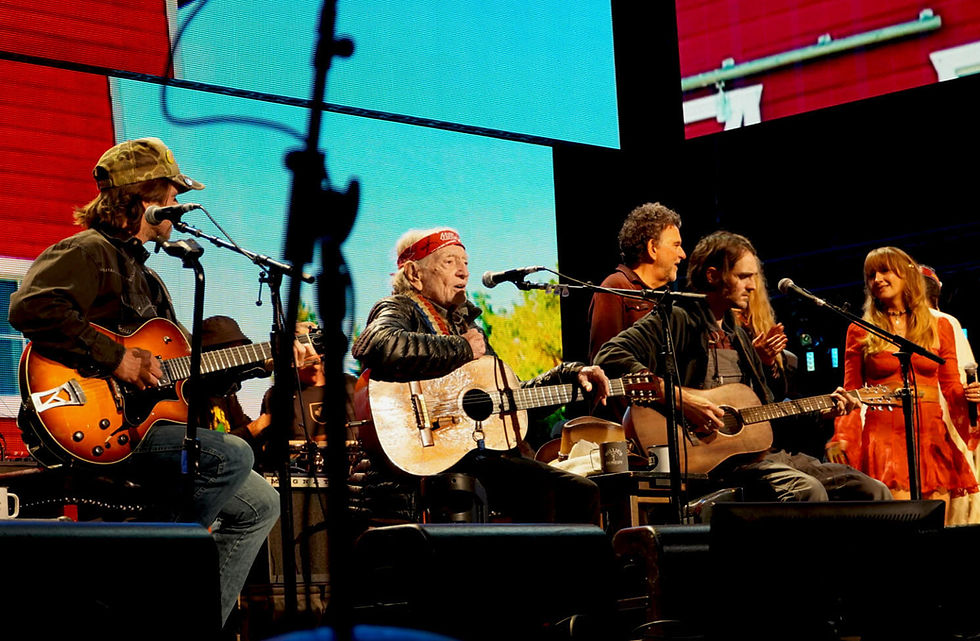 Performers from the concert's 17 acts are invited to take part in the finale. Country music star Margo Price, the woman in the red dress, is a member of the Farm Aid Board of Directors. Photo by Bob Benenson