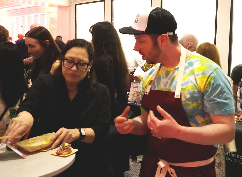 Chef-owner Sam Zeitlin of Zeitlin's Delicatessen with Axios Chicago journalist Monica Eng. Photo by Bob Benenson