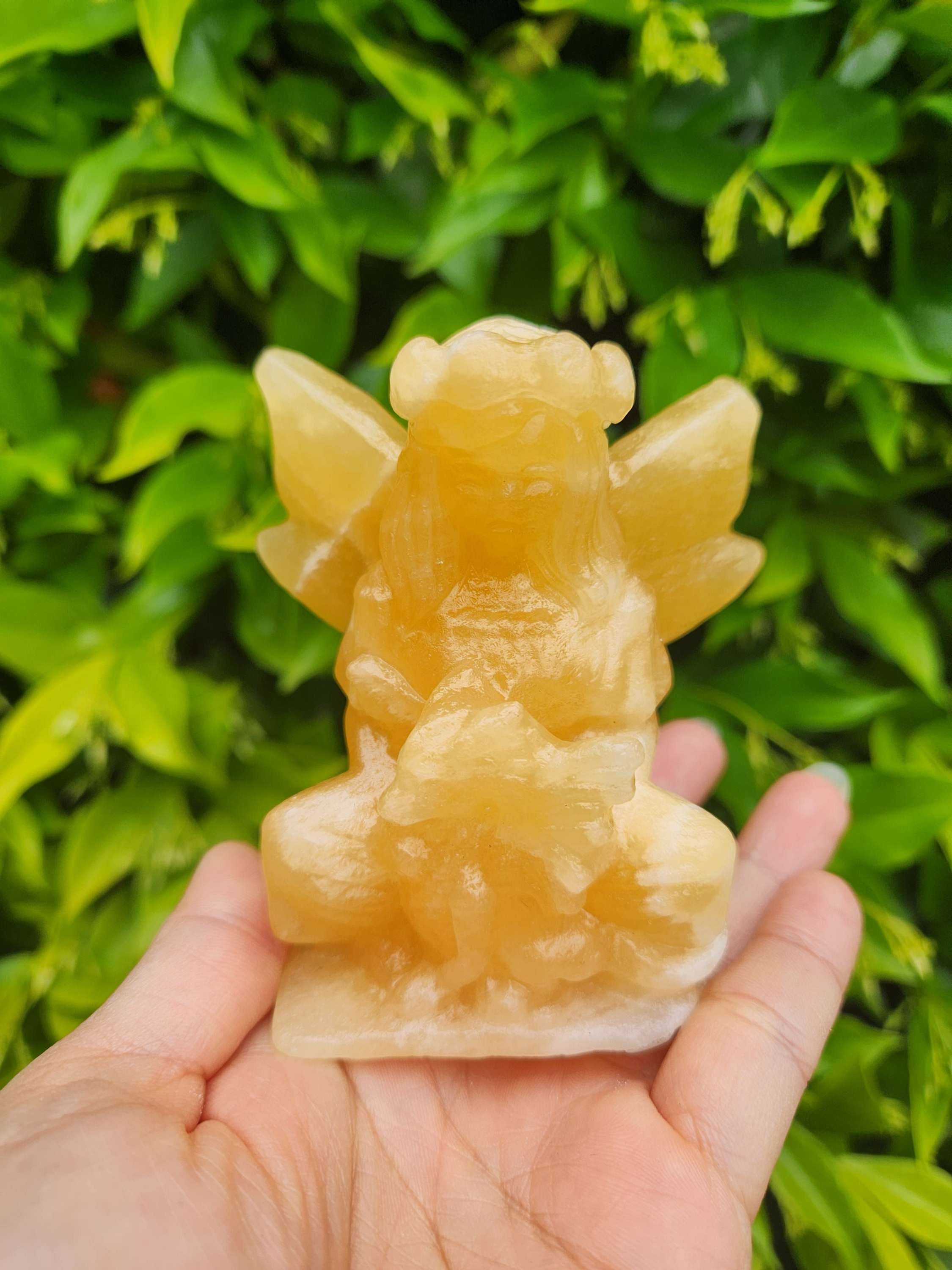 Orange calcite fairy with baby dragon 