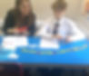 Melissa and a child working with magnetic letters on a table in a classroom.