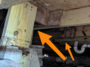 arrows point at 2x6 used to support the home in the crawlspace.