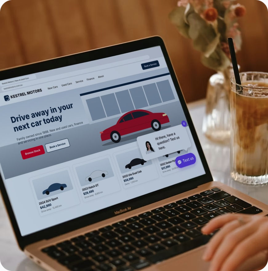 Laptop showing a dealership website with the violet WebText text-us widget