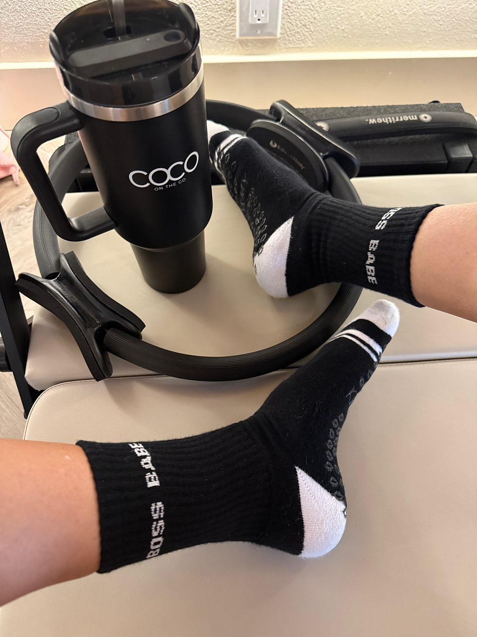 Thumbnail: Lifestyle shot of black grip socks worn during a reformer-style studio workout, showing stability and grip placement.