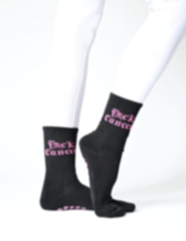 Black grip socks worn on legs with pink 'FXCK Cancer' text, shown against a white background.