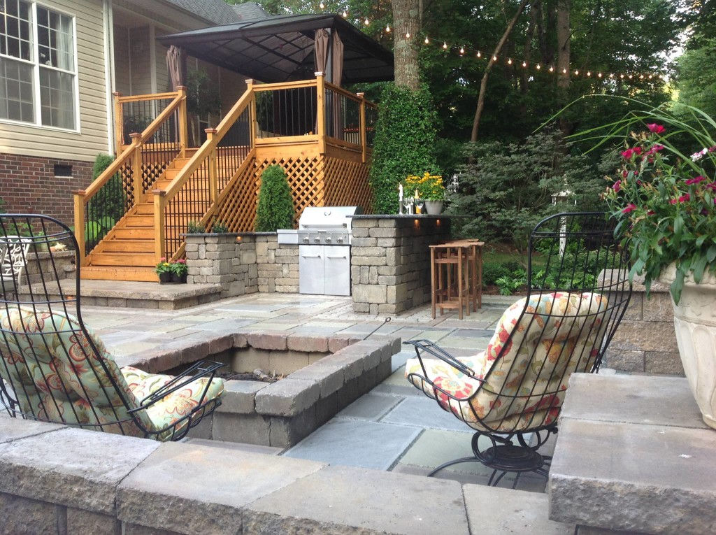 Modern large patio with stone fire pit and outdoor kitchen