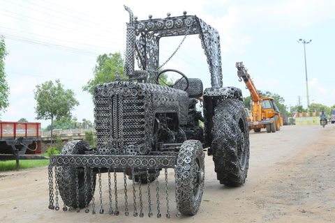 Life-size tractor sculpture crafted from welded iron scrap by Surya Silpasala (Katuri Sculptures) – celebrating rural strength through recycled art