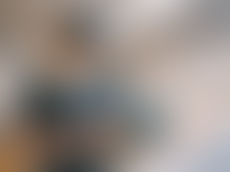 A medical trainee practicing inside a VR simulation while standing beside a real clinical mannequin in a training lab.