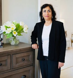 Real Estate Broker, Ransa - owner of site- posing in black suite jacket with white blouse and black suit pants