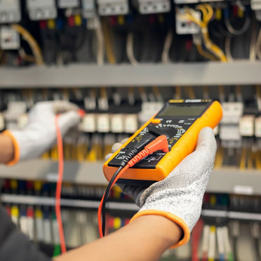 Image of an installation professional working on an electrical system in adherence with NEC 2026