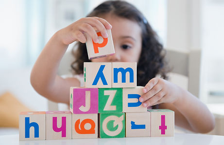 todder stacking blocks in home child care location