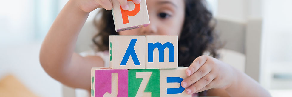 girl, boy, building blocks, stacking, order, stack, size, small, large, square, letter, capital, put together, on top, concentrate, hold with hands, balance, make words, read, write, think, believe, achieve, goal, purpose, set, short nails, curly hair, long, brown, black, shadow, echo, blurry background, good camera, fine motor skills, develop, strengthen, improve, look at, honest, reliable, trustworthy, wooden block, toy, playing, learning, study, preschool, school, provider