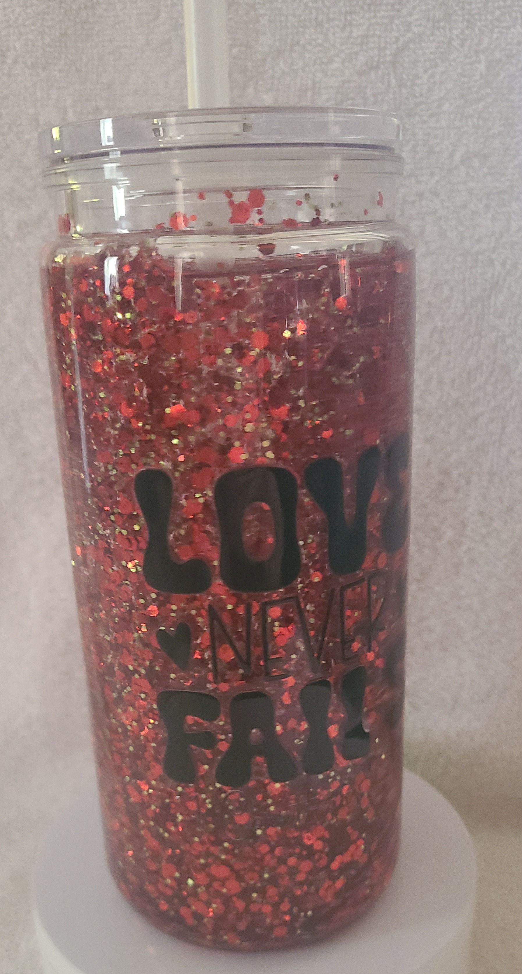 Love Never Fails Christian 20 ounce Snowglobe tumbler