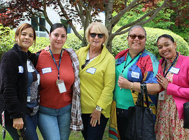 Group of employees pose for photo at agency summer event.