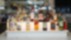 Various liquor bottles displayed on a bar with bottles and labels clearly visible.