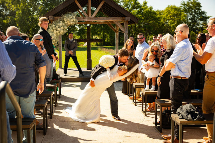 Dip kiss at outdoor garden ceremony area in Central Ohio