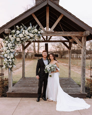 Bride and groom at chapel outdoor ceremony area at Columbus barn wedding venue