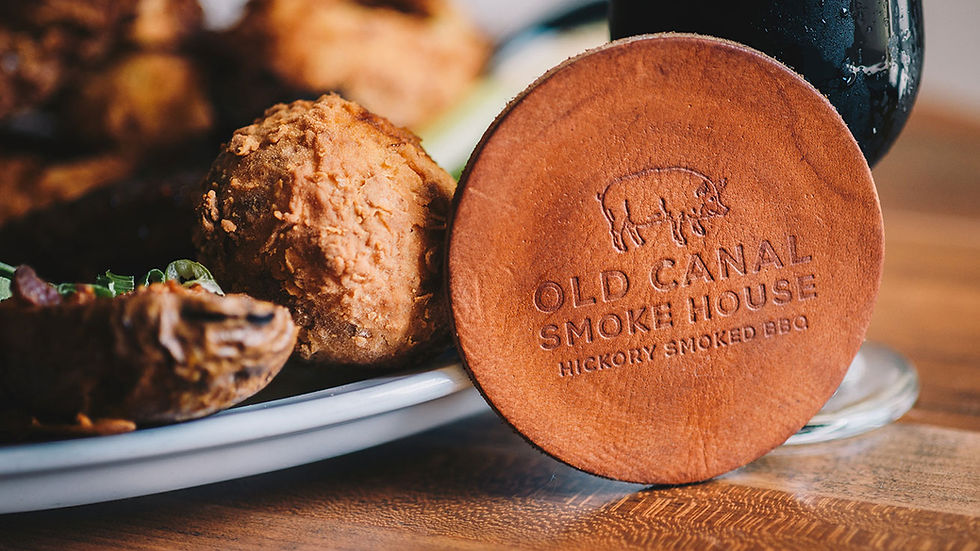 Ohio Wedding Venue. Fried food on a plate with a wooden coaster inscribed "Old Canal Smoke House, Hickory Smoked BBQ," and a dark drink on the side.