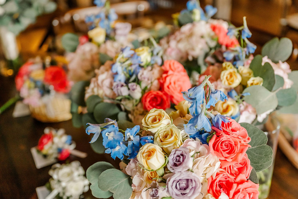 Grove City, OH Wedding Venue Colorful flower bouquets with roses and blue blooms arranged on a table indoors, soft focus background, warm romantic mood