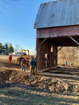 barn being moved with tractor