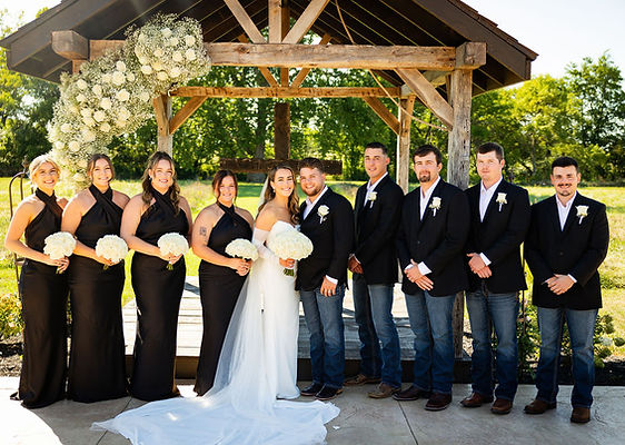 Bridal party in black with bride and groom in chapel ceremony area at Columbus wedding venue