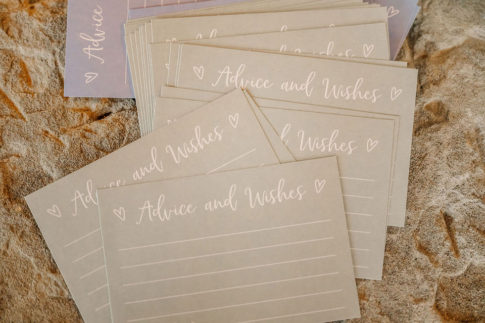 Barn Wedding Venues in Ohio. Stack of beige cards on textured surface, labeled "Advice and Wishes" with hearts in white script.