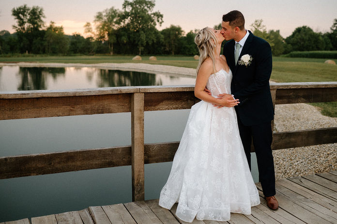 Bride and groom on bridge over pond at Columbus barn wedding venue