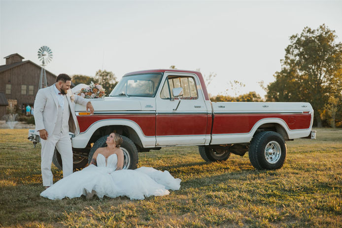 Bride and groom with classic 77 ford truck at Central Ohio wedding venue