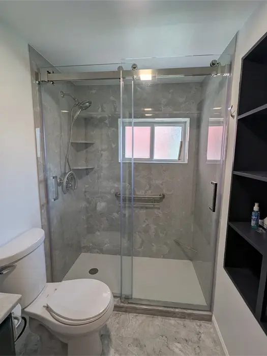 Frameless heavy glass bypass shower door with no threshold entry