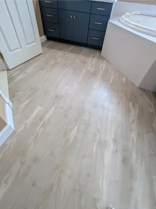 Luxury vinyl tile bathroom floor with wood-look finish